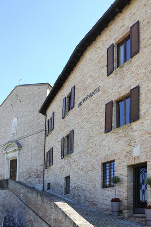A building with a sign reading "RISTORANTE" and a staircase leading to the entrance. - Albergo Diffuso Borgo Montemaggiore (Colli al Metauro)