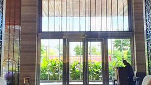 A spacious lobby with a high ceiling, large windows, and a central seating area. - Halong Palace Hotel (Bai Chay)