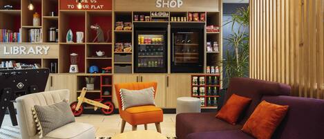 A modern interior with a library, shop, and seating area.