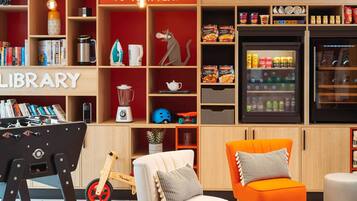 Relax in a well-organized space with a library, kitchenette, and comfortable seating.