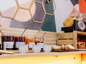 A breakfast buffet with various food items and condiments. - Aparthotel Adagio Access Nancy Centre (Nancy)
