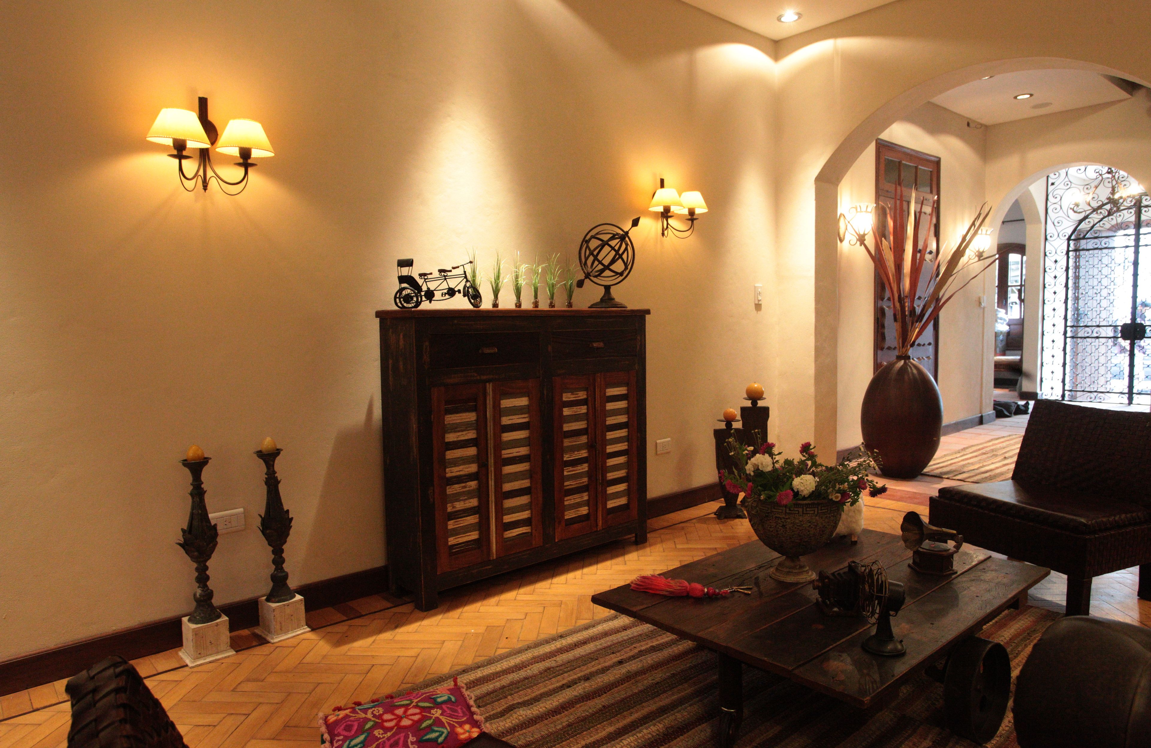 A lobby with a wooden cabinet, a coffee table, and a sofa.