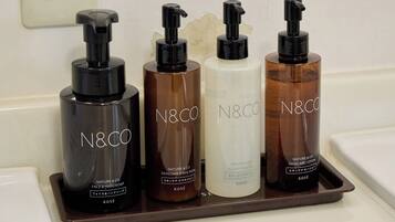 Four N&CO skincare products on a tray.