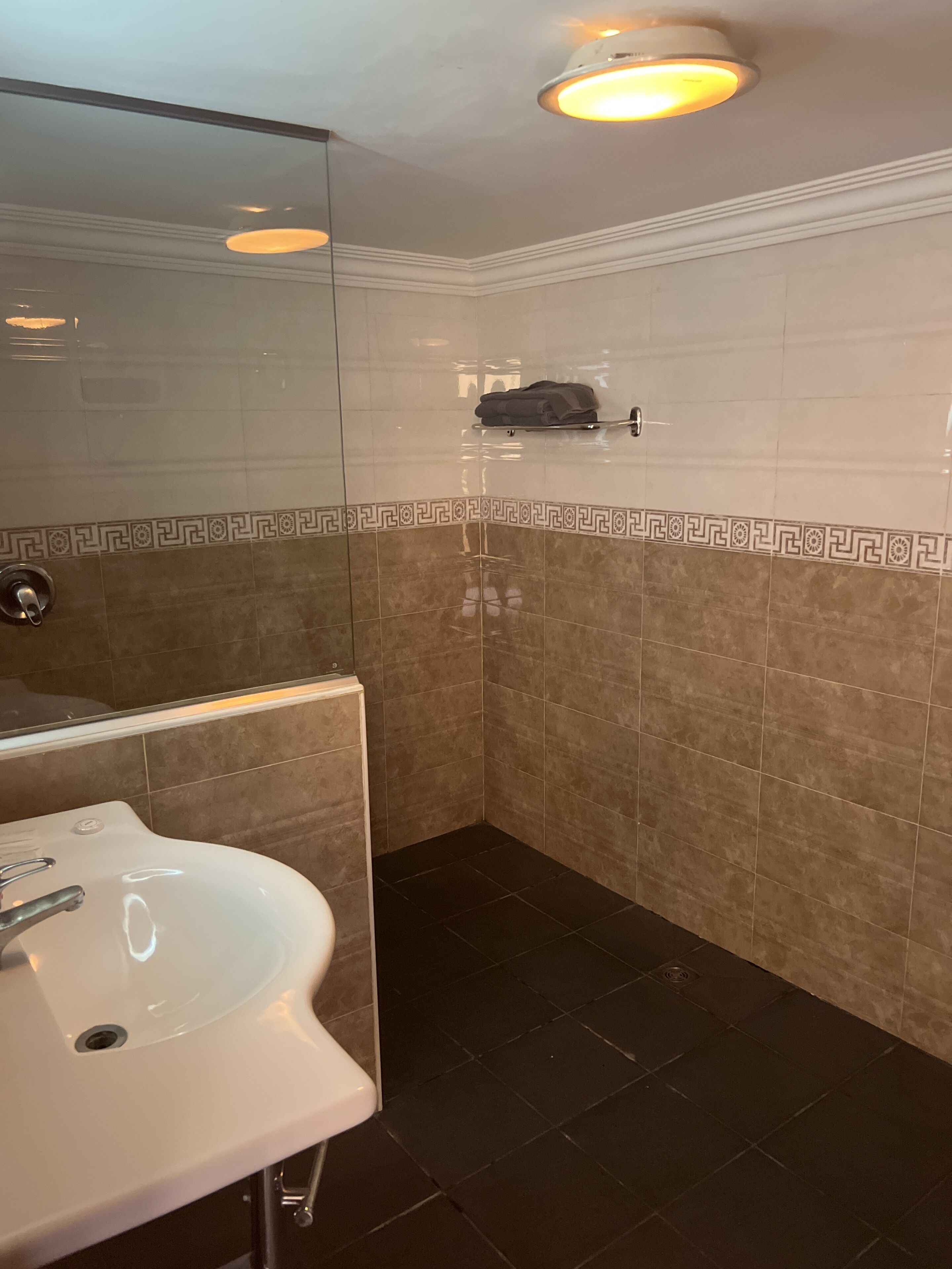 shower, hair dryer, slippers, towels