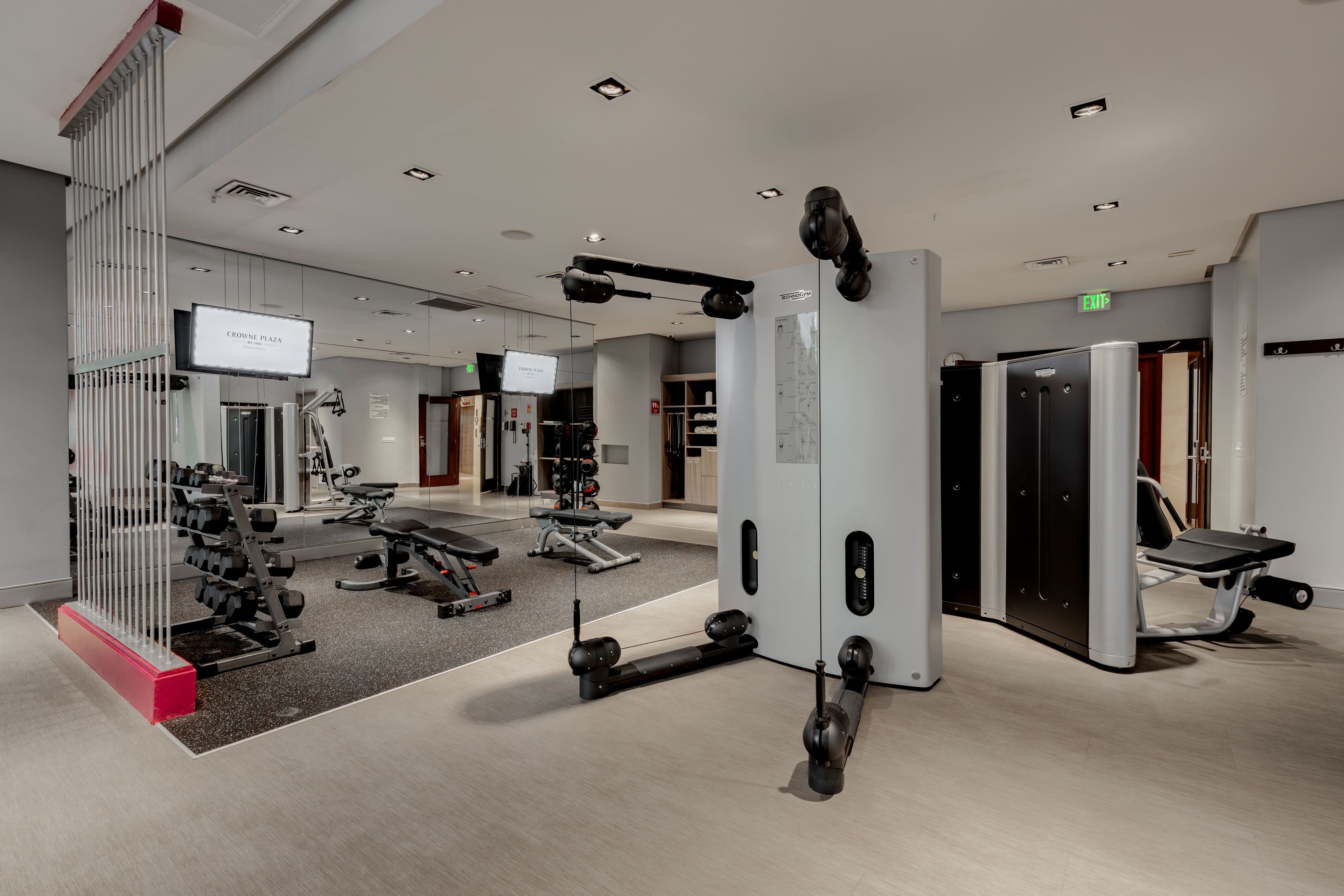 A gym with various exercise equipment, including weight machines and free weights.