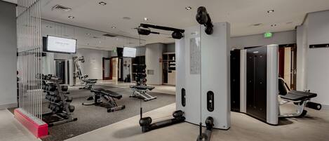 A gym with various exercise equipment, including weight machines and free weights.