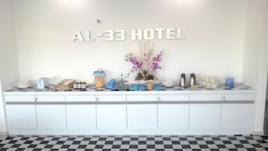 A hotel reception area with a checkered floor, a counter with various amenities, and a wall sign reading "AL-33 HOTEL". - Sun Inns Hotel Laksamana (Malacca City)