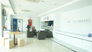 A hotel lobby with a reception desk, seating area, and a children's play area. - Sun Inns Hotel Laksamana (Malacca City)