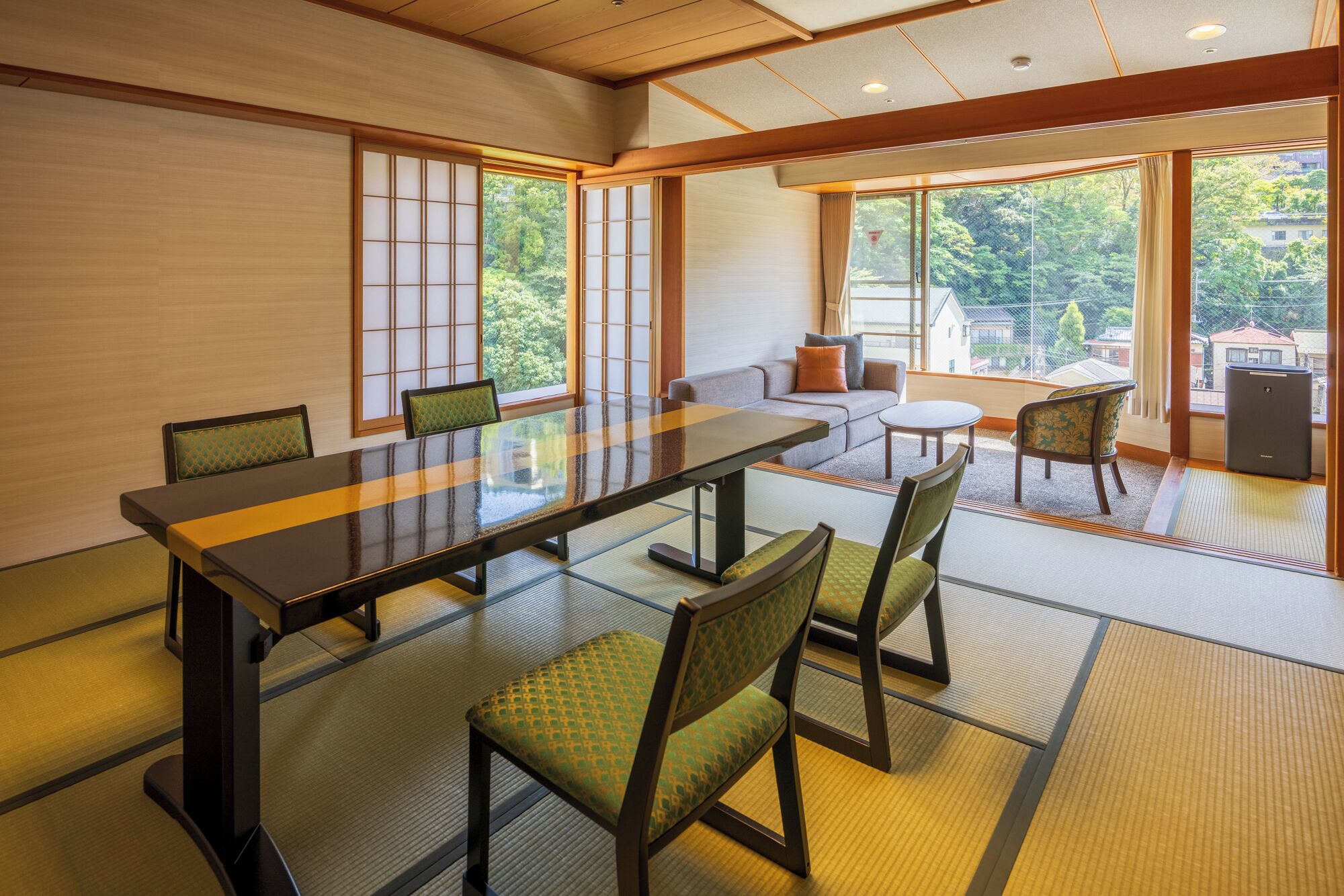 A traditional Japanese-style room with tatami flooring, a low table, and shoji screens.
