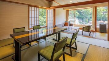 A traditional Japanese-style room with tatami flooring, a low table, and shoji screens.