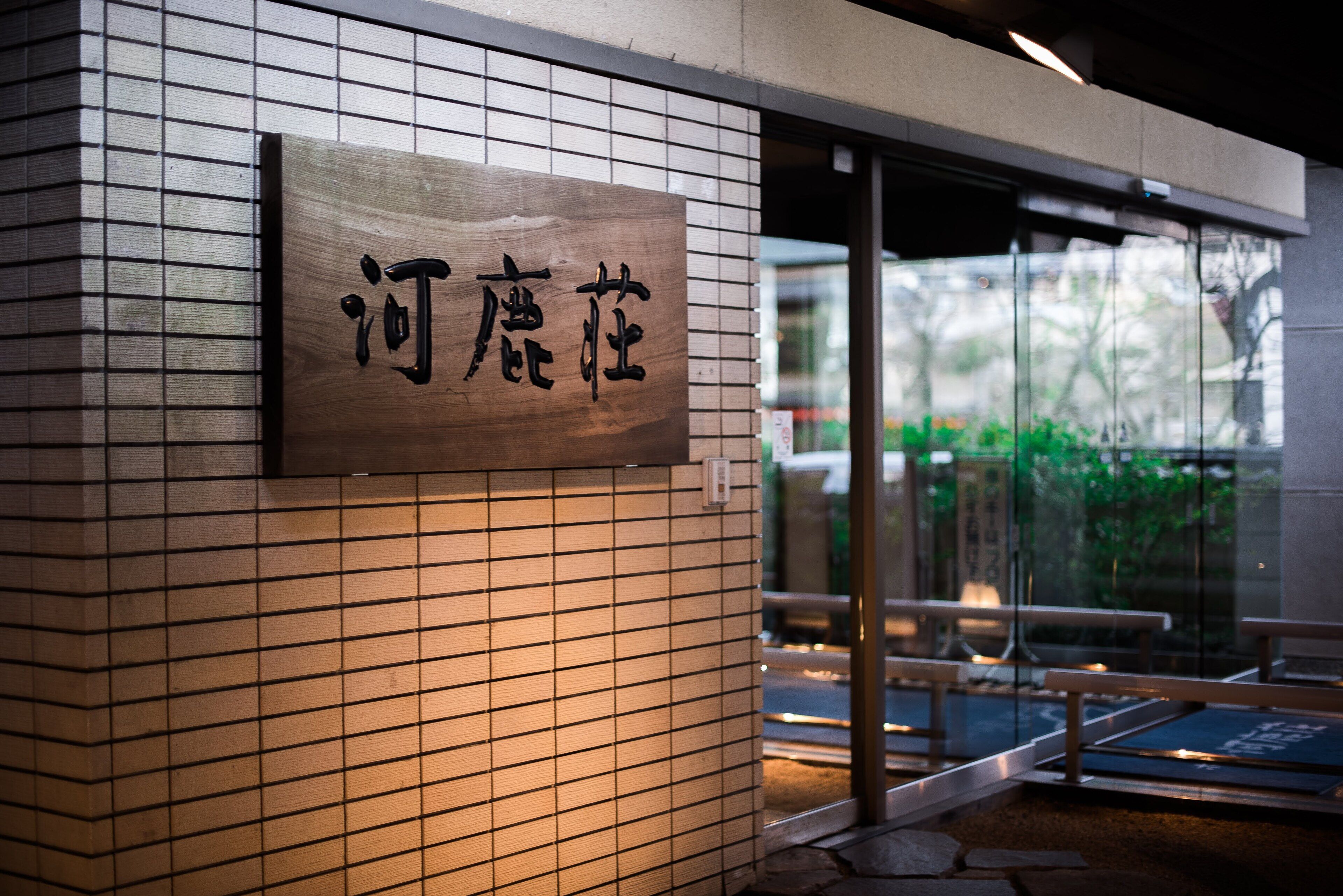 A sign with Chinese characters on a tiled wall, indicating a location.
