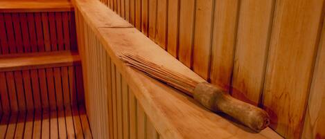 Un banc de sauna en bois doté d’une longue poignée.