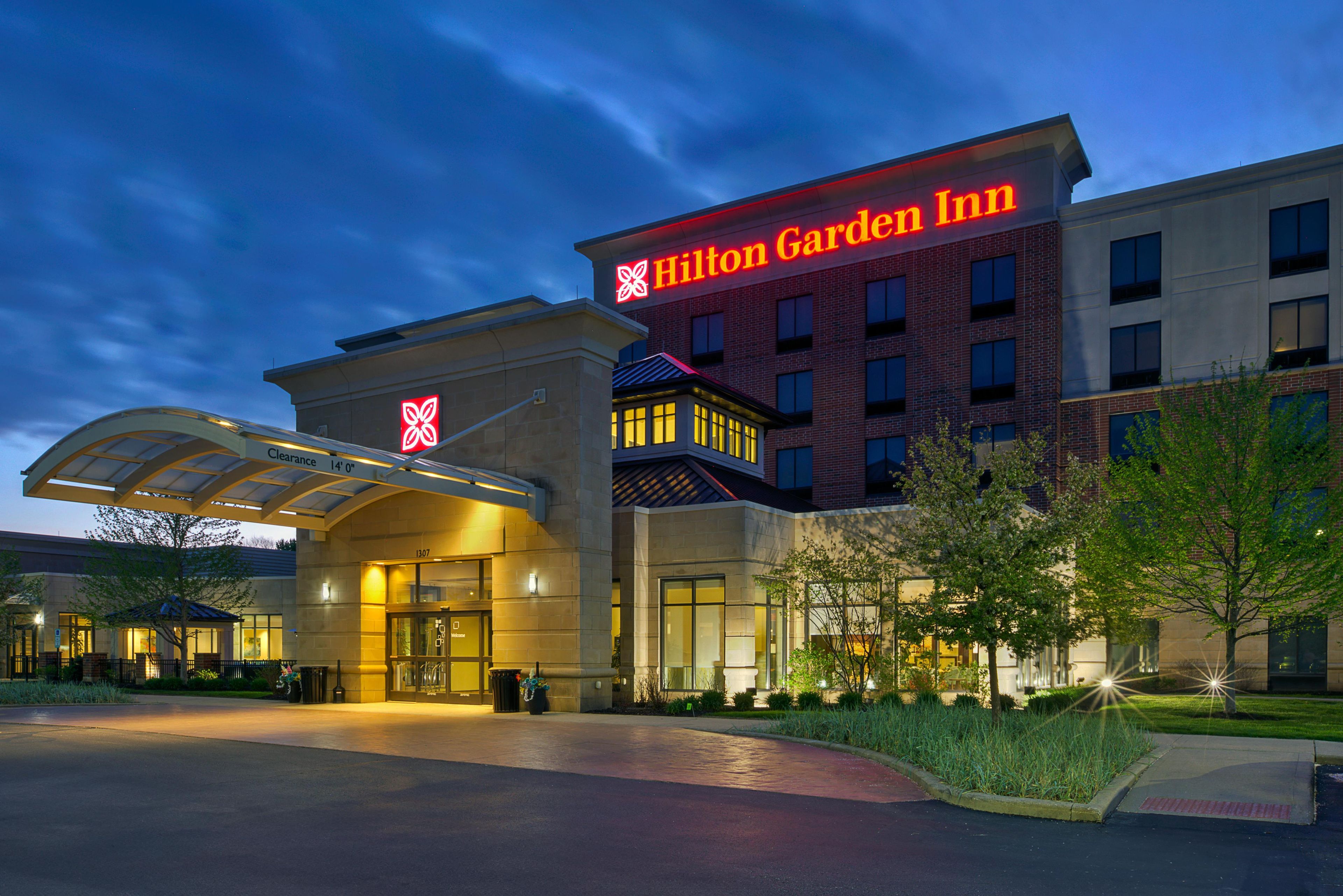 A Hilton Garden Inn with a clear entrance, a large sign, and a well-lit facade.