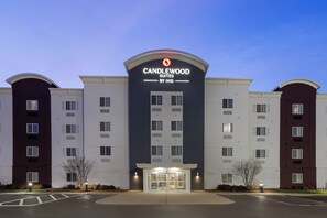 A hotel with a modern design, featuring a prominent entrance and multiple floors. - Candlewood Suites Fort Campbell - Oak Grove by IHG (Oak Grove)
