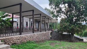 A covered outdoor area with stone walls and a metal fence. - Hotel Casa La Gran Senora (Tequila)