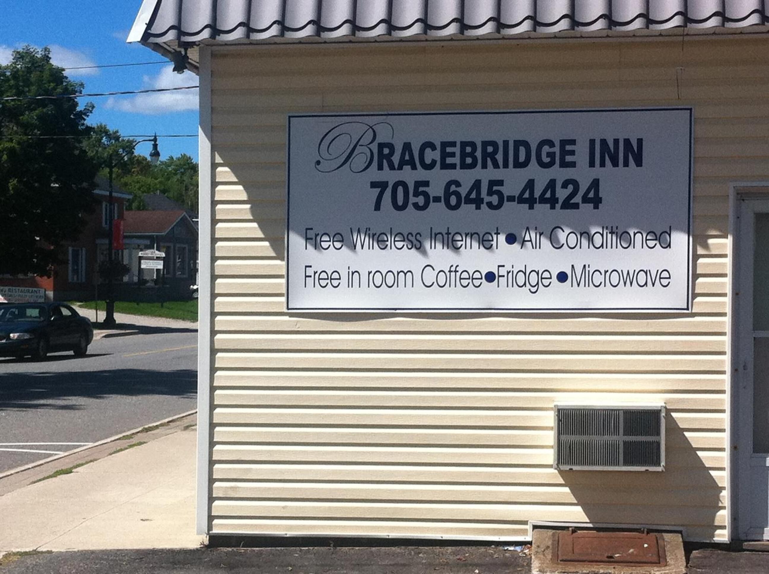 Letrero de Bracebridge Inn con servicios que incluyen internet inalámbrico gratuito, aire acondicionado, café en la habitación, refrigerador y microondas.