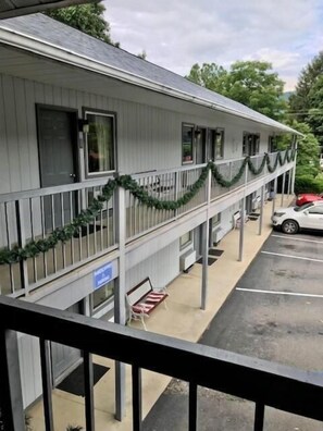 Welcome to a cozy retreat with a covered porch, bench, and parking available.