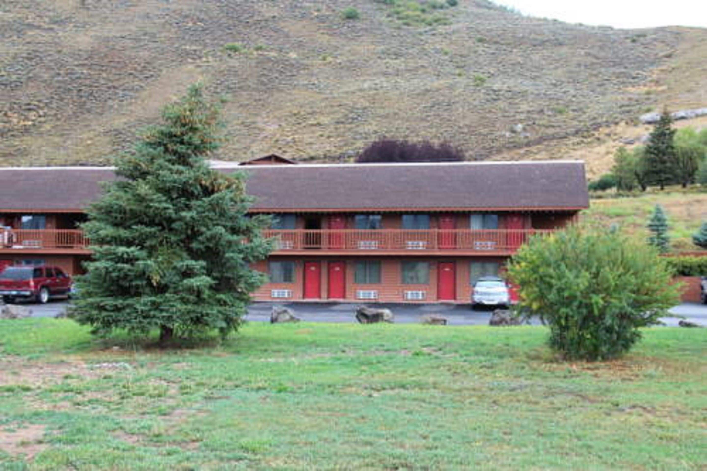A two-story lodge with a red exterior and a balcony on the upper floor.