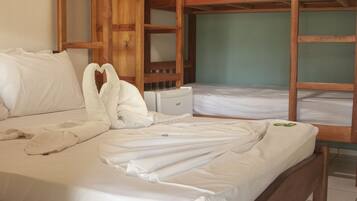 A room with a wooden bed, a wooden bench, and a small table.
