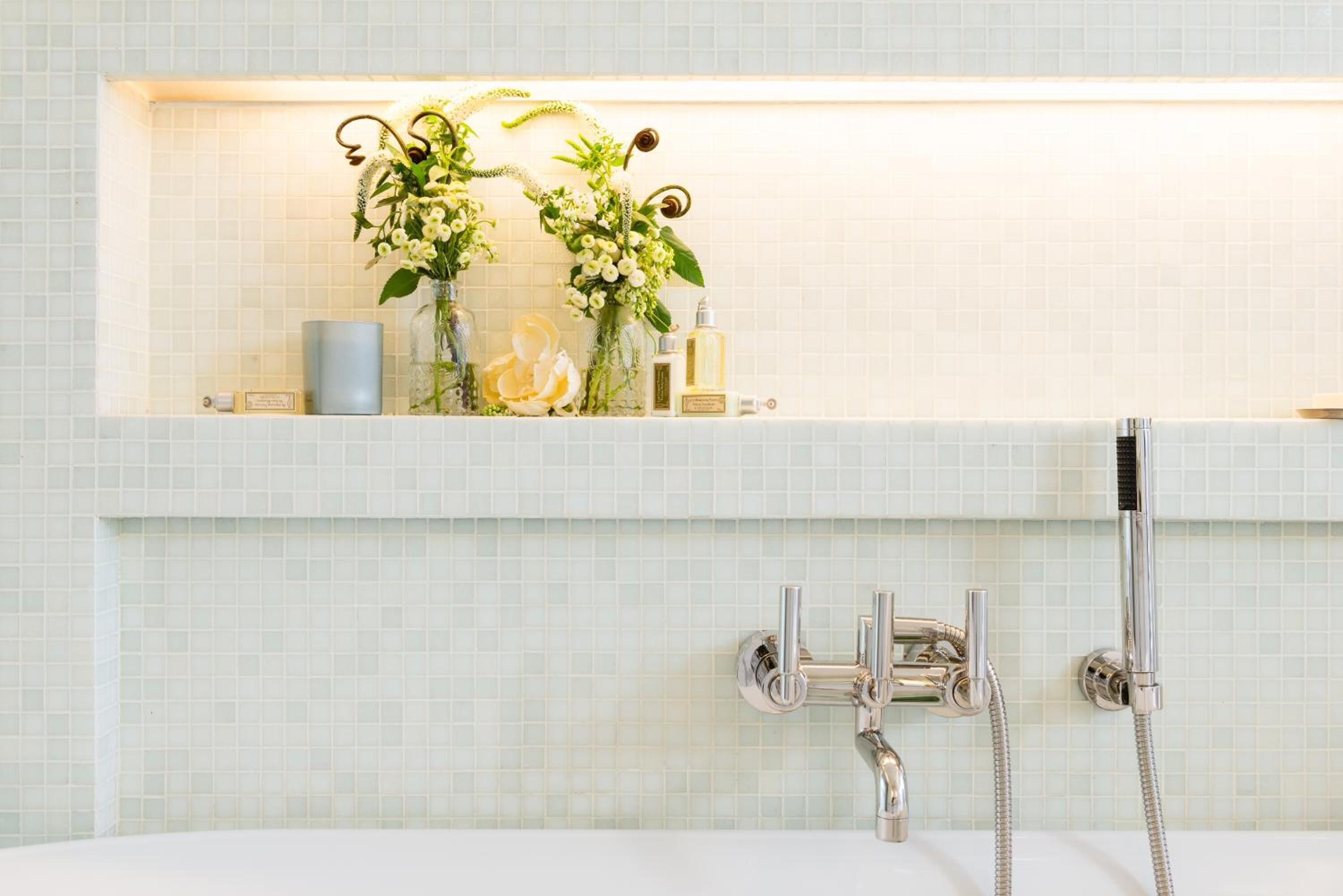 designer toiletries, hair dryer, slippers, towels