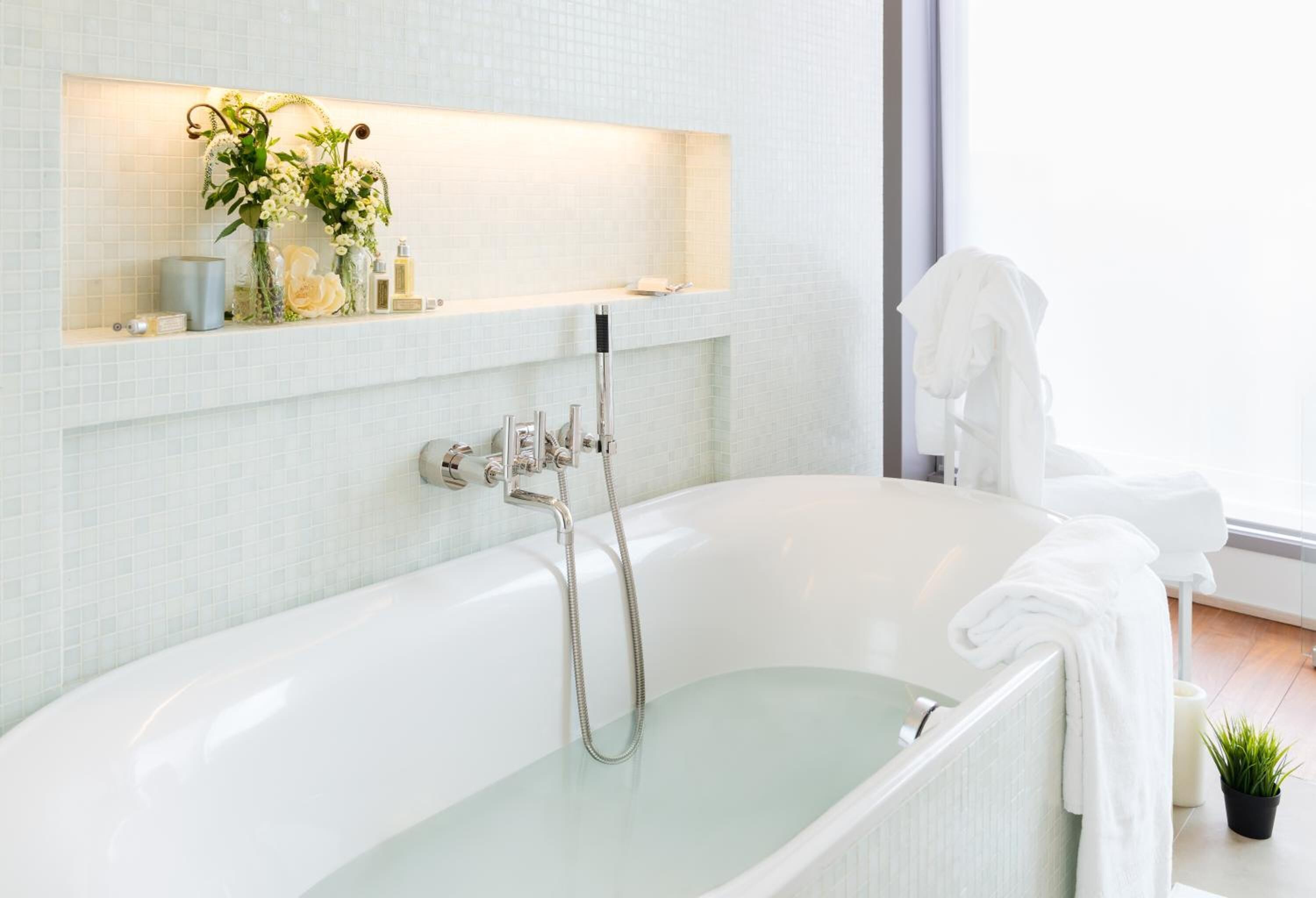 designer toiletries, hair dryer, slippers, towels