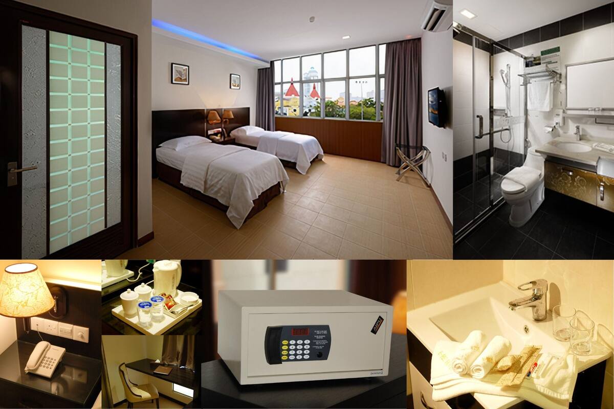 A hotel room with two beds, a bathroom, a minibar, and a telephone.