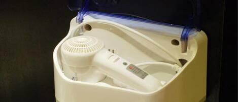 A white portable heater with a blue plastic cover, a power cord, and a control panel.