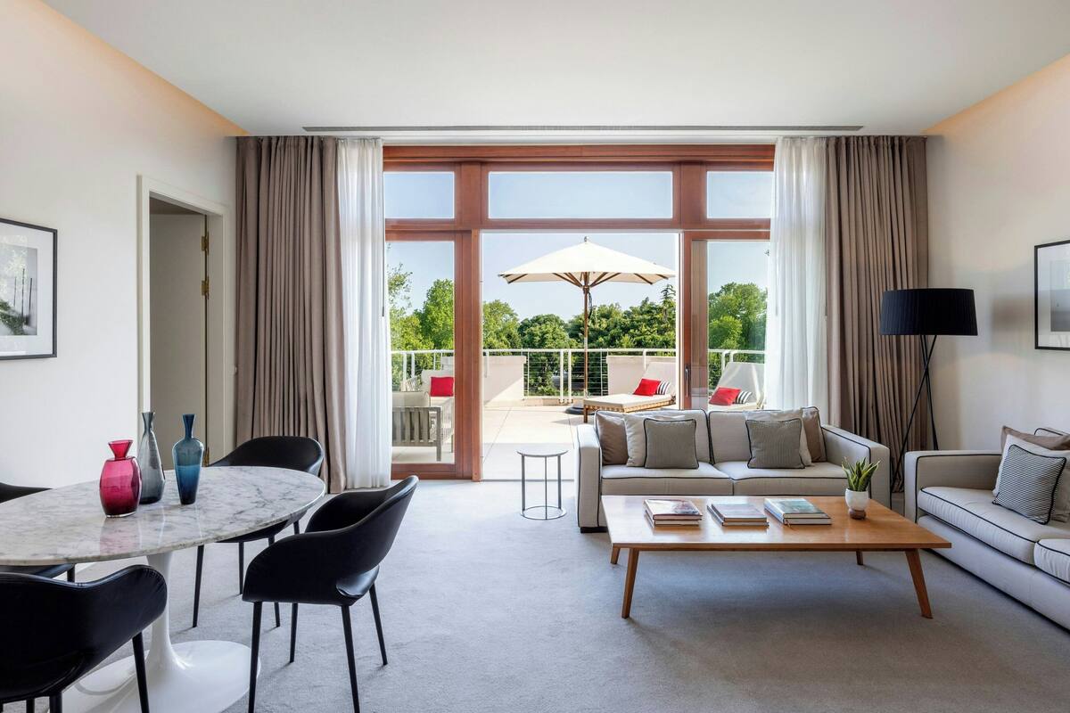 A modern living room with a round table, two sofas, and a coffee table.