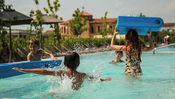 Guests can enjoy a refreshing swim in the resort's open-air pool surrounded by lush greenery and scenic views.