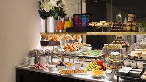 A buffet with various food items, including fruits, pastries, and condiments. - Hôtel Le Marianne (Paris)