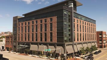 A modern hotel with a brick facade, large windows, and a flat roof.