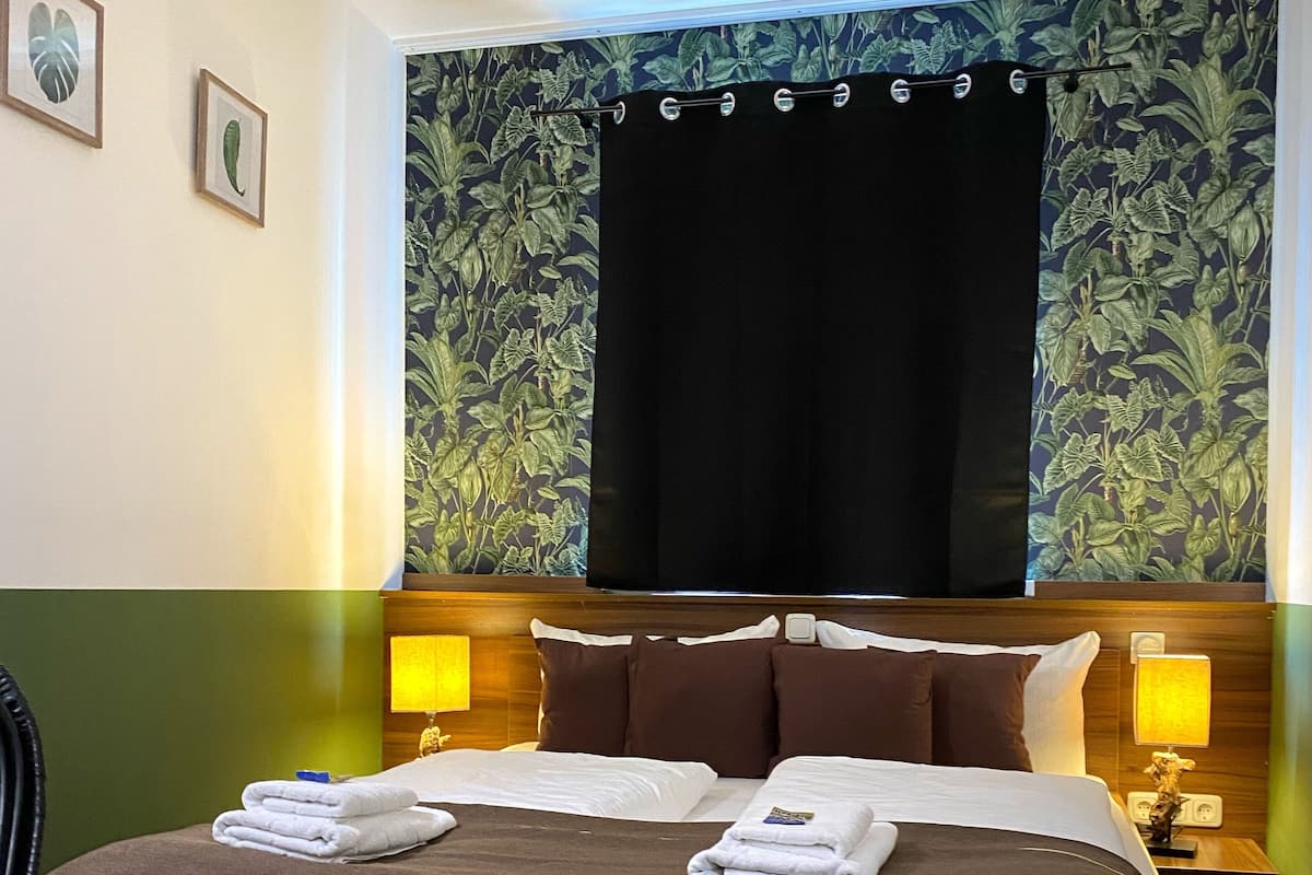 Green Lounge | Premium bedding, desk, laptop workspace, blackout drapes