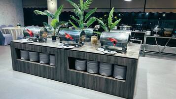 A buffet setup with multiple self-service stations, each with a metal container and a red napkin.