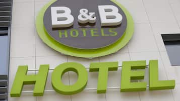 A B&B hotel sign with a circular logo and the word "HOTEL" in large green letters.