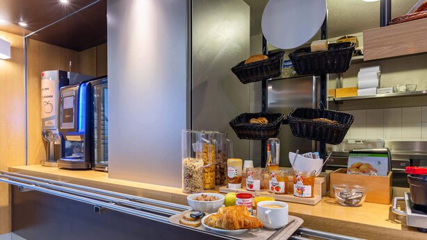 A breakfast buffet setup with various food items and a coffee machine. - B&B HOTEL CHARTRES Le Forum (1) (Le Coudray)