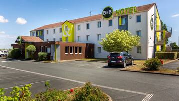 Stylish B&B Hotel with a two-story design, featuring a flat roof and landscaped grounds.