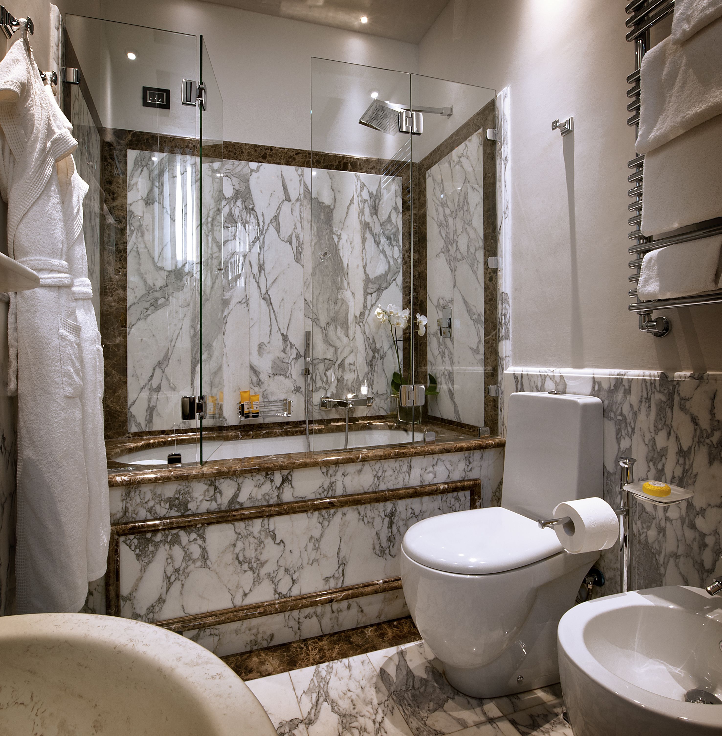 Designer toiletries, hair dryer, slippers, bidet