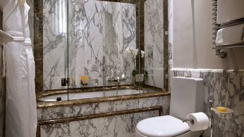 Designer toiletries, hair dryer, slippers, bidet