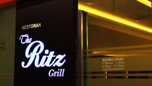 A sign for The Ritz Grill restaurant with business hours listed. - Seasons View Hotel (Kuantan)