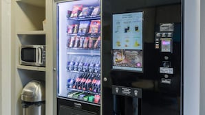 A vending machine with snacks, beverages, and a microwave. - B&B HOTEL Metz Jouy-aux-Arches (Jouy-aux-Arches)