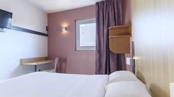 Premium bedding, desk, laptop workspace, blackout drapes