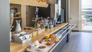 A breakfast buffet with various food items and beverages.