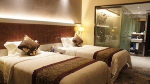 A hotel room with two beds, a glass shower enclosure, and a bathroom with a sink and mirror. - Shenzhen Lido Hotel (Shenzhen)