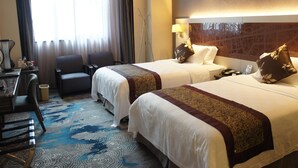A hotel room with two beds, a desk, a chair, and a view of the city through large windows. - Shenzhen Lido Hotel (Shenzhen)