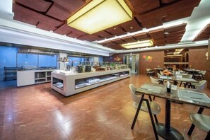 A spacious buffet area with a long counter and multiple seating arrangements. - Qindao International Hotel (Ningbo)