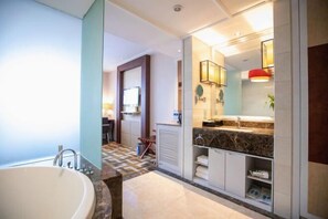 A modern bathroom with a freestanding bathtub, a vanity with a marble countertop, and a shower area. - Haina Baichuan Hotel (Ningbo)