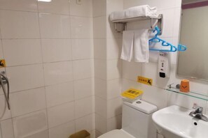 A bathroom with a toilet, sink, and towel rack. - Hejia Inn (Beijing Fuwai Hospital) (Beijing)