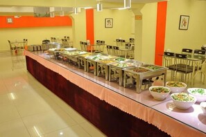 A buffet setup with multiple food stations and dining tables. - Hejia Inn (Beijing Fuwai Hospital) (Beijing)