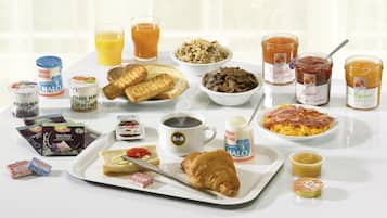 A breakfast spread with various food items and beverages.