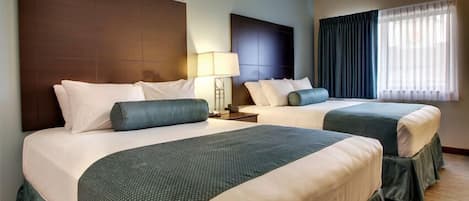 Premium bedding, pillow-top beds, desk, laptop workspace